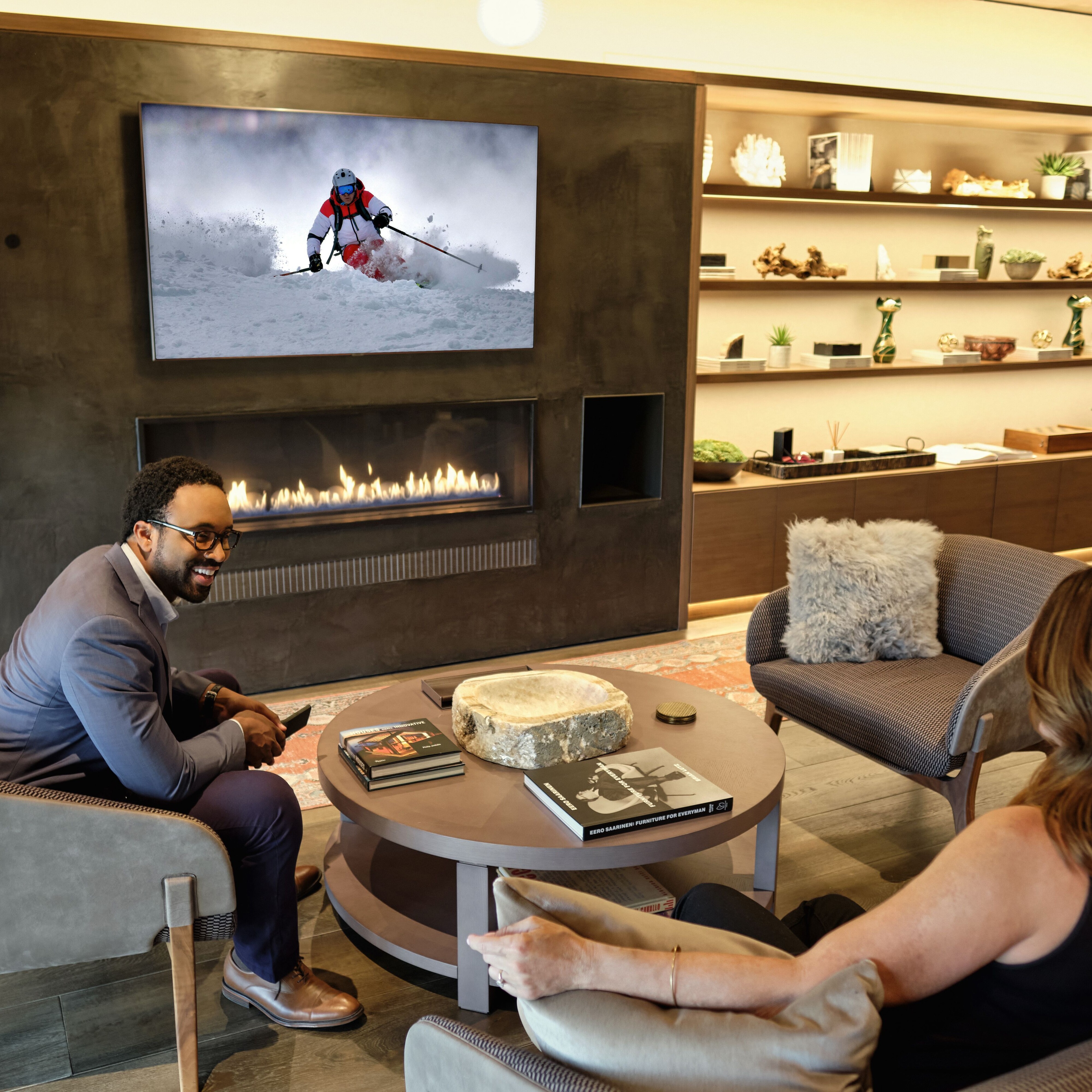 Couple Seating in a Modern Living Room Sports on a Seura TV Mirror