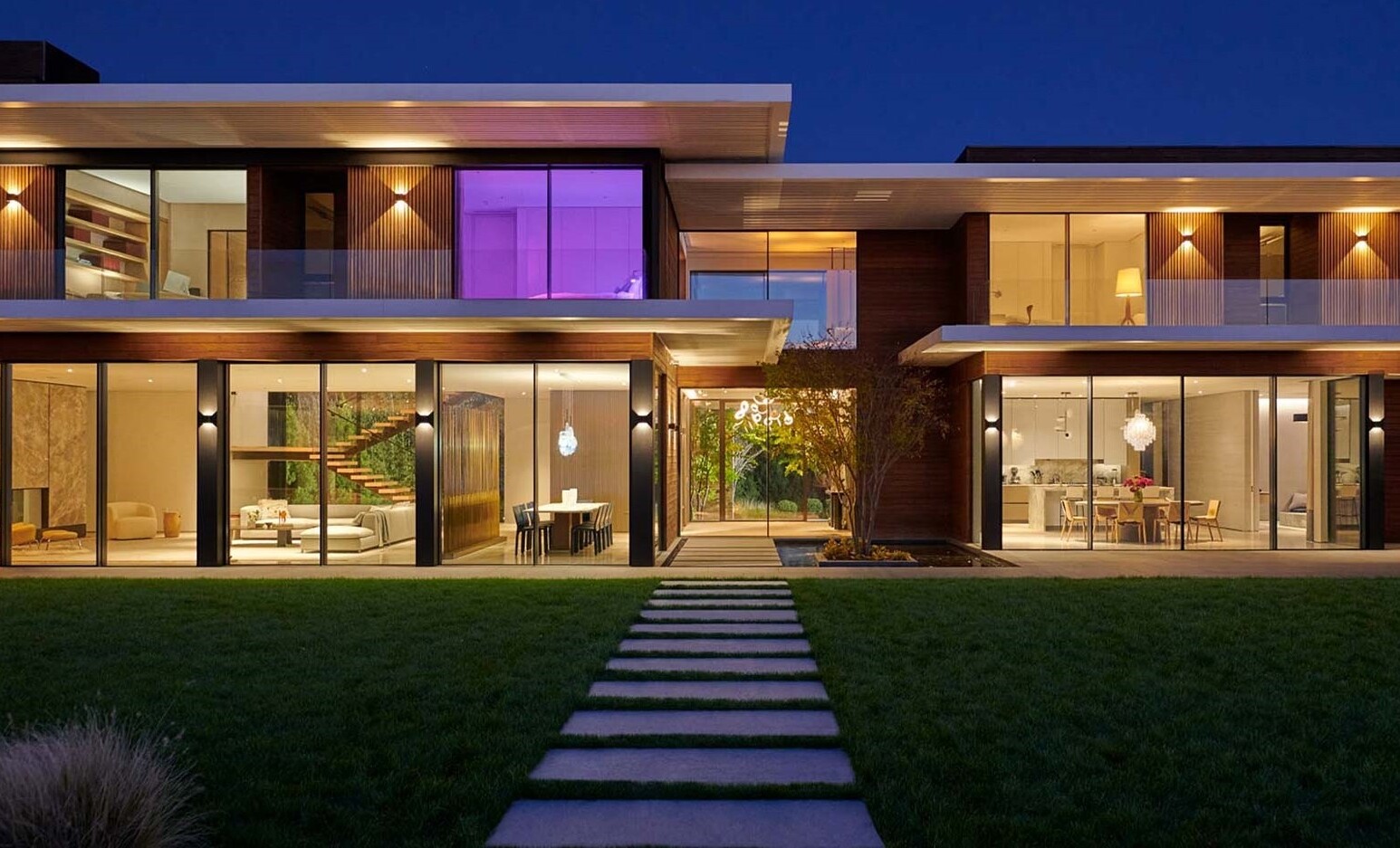 Exterior Evening View Minimalist Two-Story Home Floor With Interior Architectural Lighting