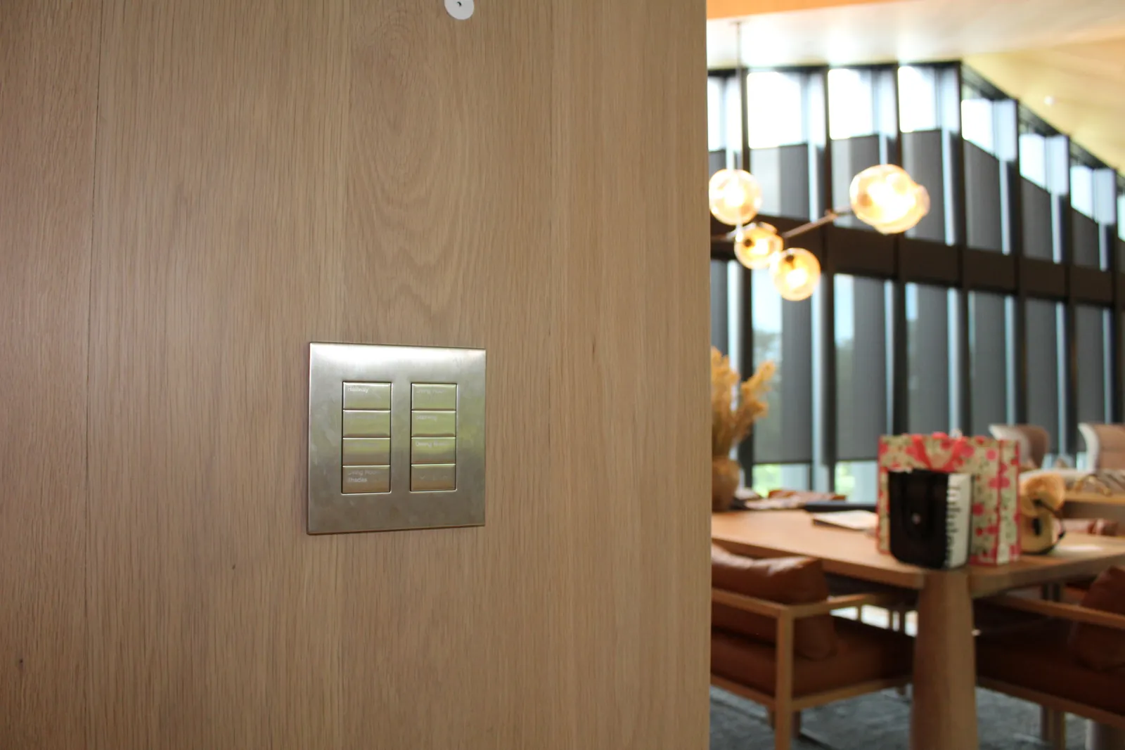 A Lutron Palladiom keypad set into a wood wall in a Stowe home